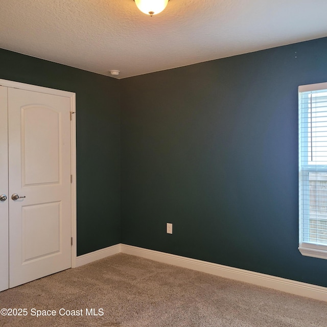 unfurnished room featuring carpet floors