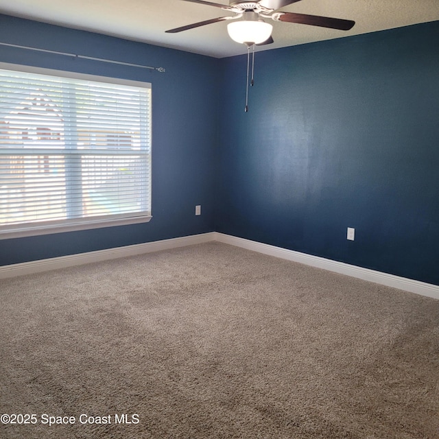 carpeted empty room with ceiling fan