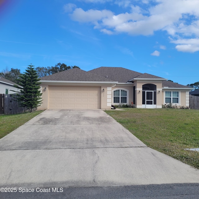 single story home featuring a garage and a front lawn