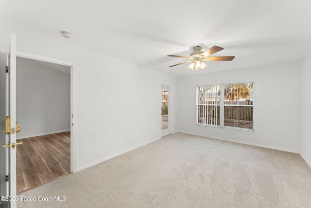 carpeted spare room with ceiling fan