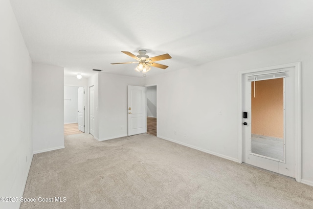 carpeted empty room featuring ceiling fan