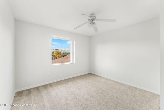 carpeted spare room with ceiling fan