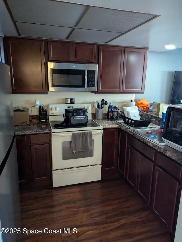 kitchen featuring a drop ceiling, dark hardwood / wood-style floors, and appliances with stainless steel finishes