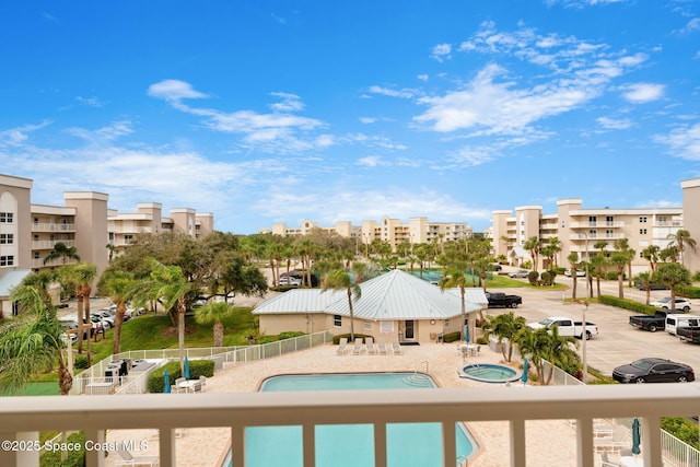 view of swimming pool with a patio area and a hot tub