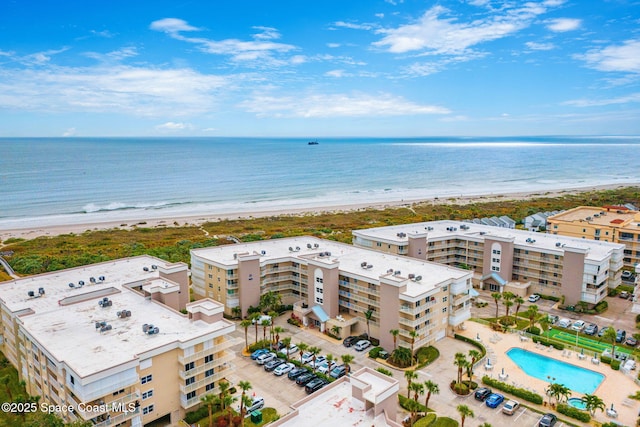 birds eye view of property with a view of the beach and a water view