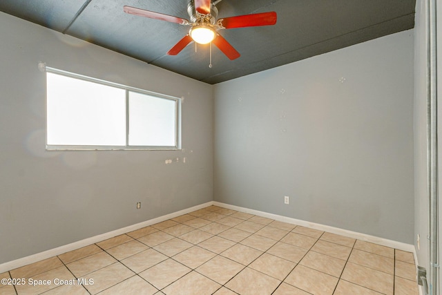 spare room featuring ceiling fan and light tile patterned flooring