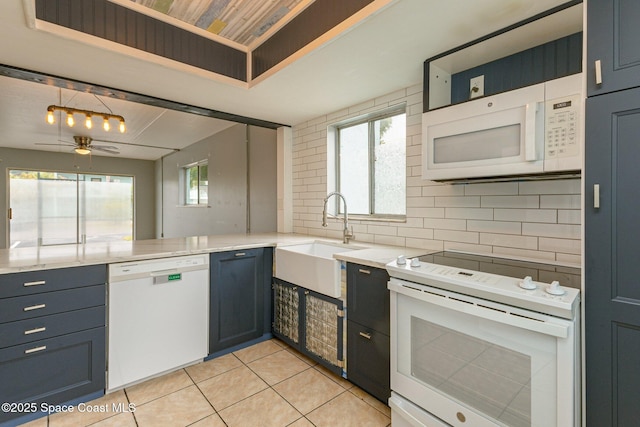 kitchen featuring sink, white appliances, ceiling fan, backsplash, and pendant lighting