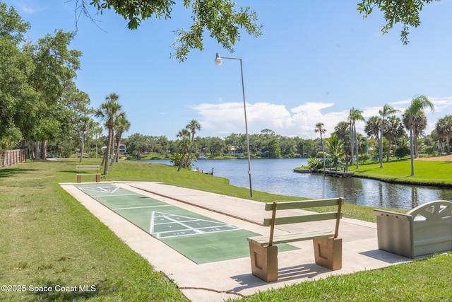 surrounding community with a lawn and a water view