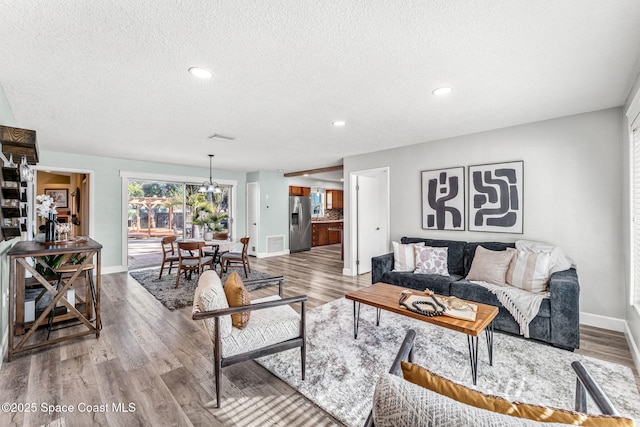 living room with hardwood / wood-style flooring and a textured ceiling