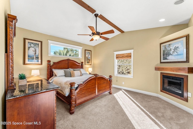 carpeted bedroom with ceiling fan, multiple windows, and vaulted ceiling with beams