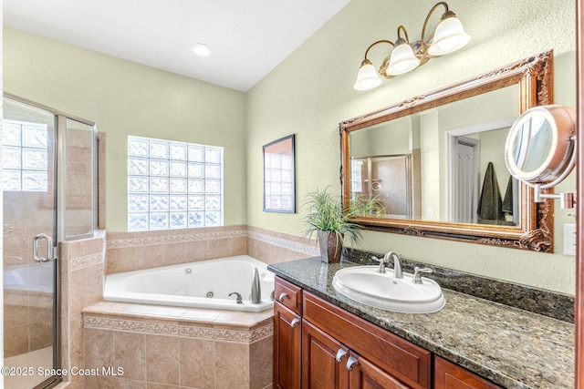 bathroom with vanity and separate shower and tub