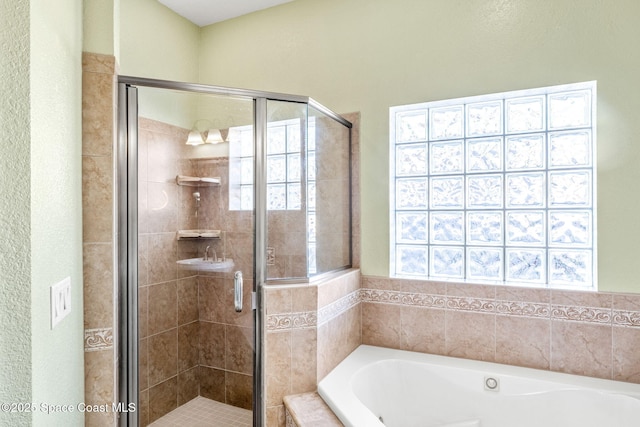 bathroom with shower with separate bathtub and a healthy amount of sunlight