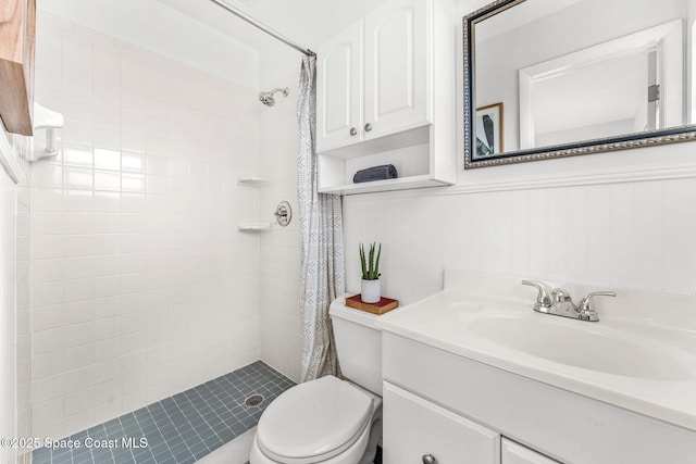 bathroom featuring vanity, toilet, and curtained shower