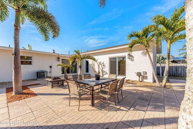 view of patio / terrace with central AC unit and an outdoor fire pit