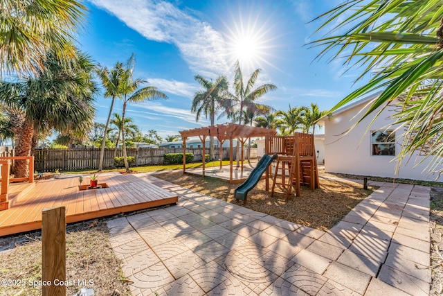 view of playground with a wooden deck