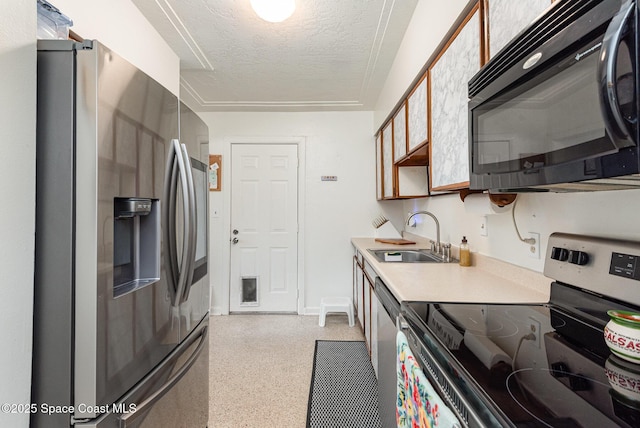 kitchen featuring appliances with stainless steel finishes, a textured ceiling, and sink