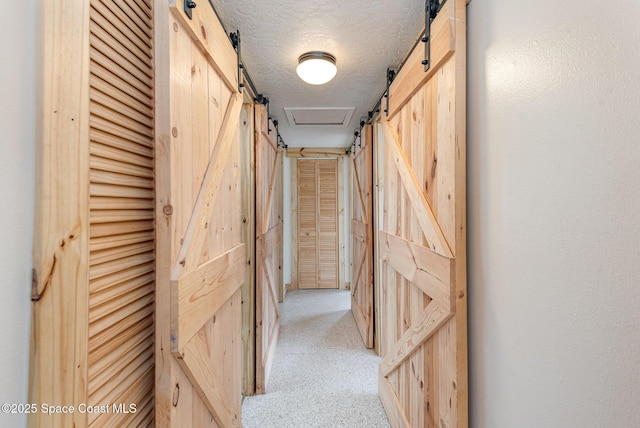 corridor with a textured ceiling