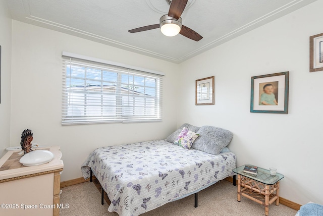 bedroom with ceiling fan and crown molding