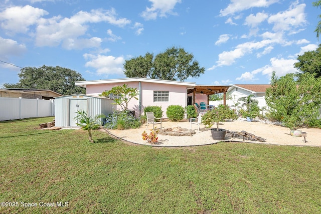 rear view of property featuring a shed, a carport, and a lawn