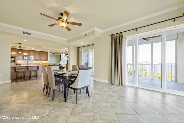 dining area featuring ornamental molding, visible vents, and baseboards