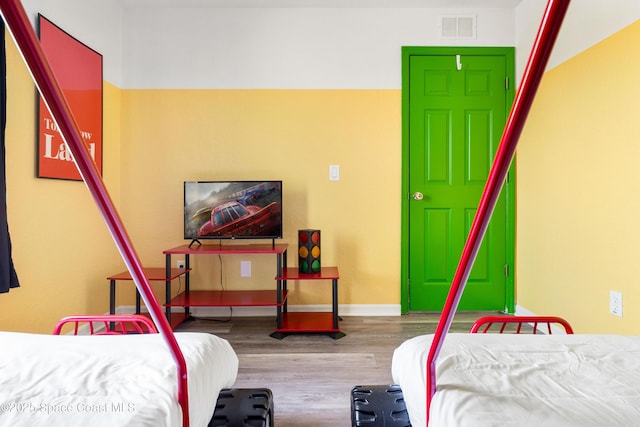 bedroom with hardwood / wood-style flooring