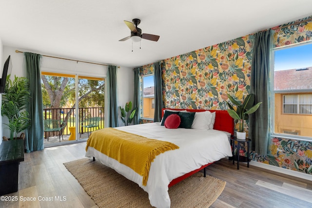 bedroom featuring ceiling fan, light hardwood / wood-style floors, access to outside, and multiple windows