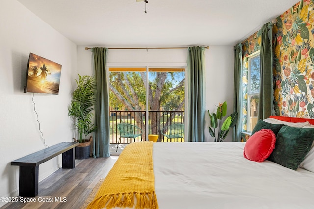 bedroom with access to outside and wood-type flooring