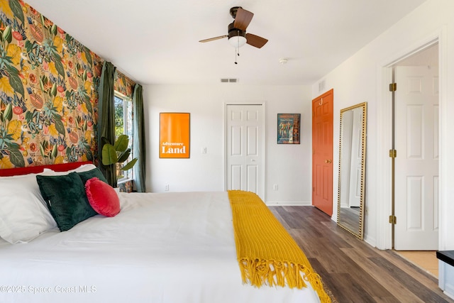 bedroom with ceiling fan and dark wood-type flooring