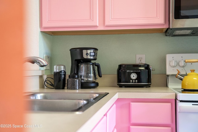 kitchen featuring sink and white stove