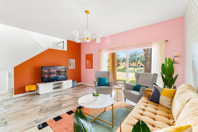 living room featuring a chandelier and light wood-type flooring