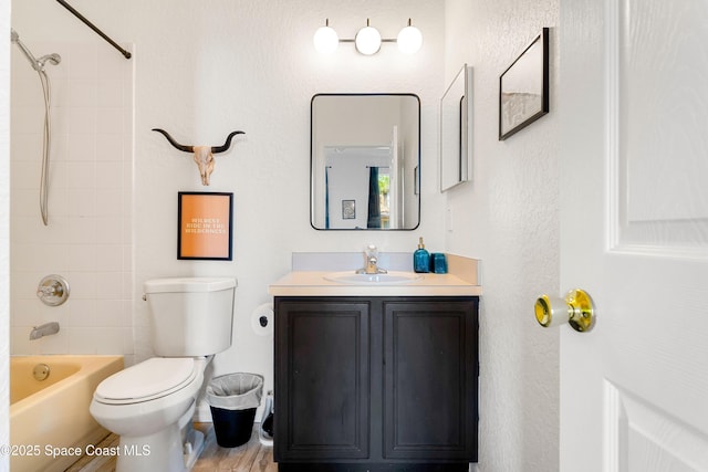 full bathroom with vanity, toilet, and tiled shower / bath