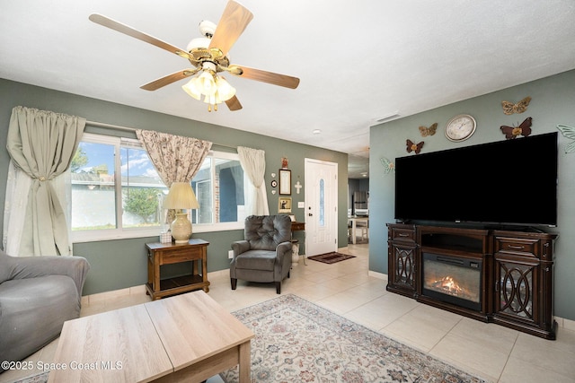 tiled living room featuring ceiling fan