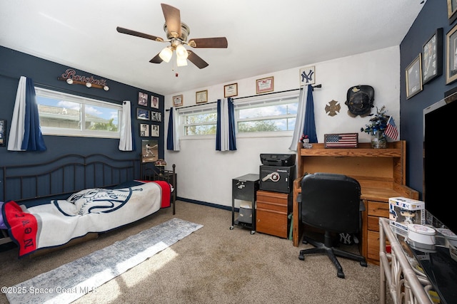 bedroom with multiple windows, ceiling fan, and carpet