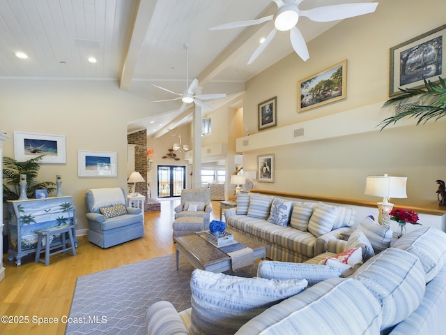 living room with beamed ceiling, ceiling fan, light wood-type flooring, and wooden ceiling