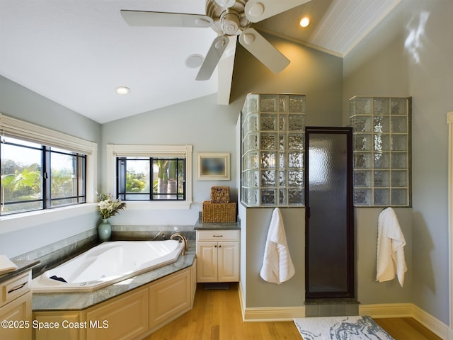 bathroom featuring vanity, ceiling fan, wood-type flooring, independent shower and bath, and lofted ceiling