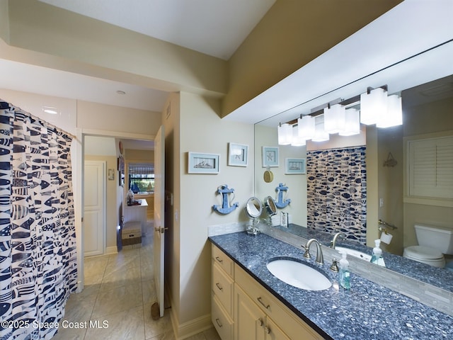 bathroom featuring vanity and toilet