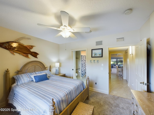 carpeted bedroom with a textured ceiling and ceiling fan