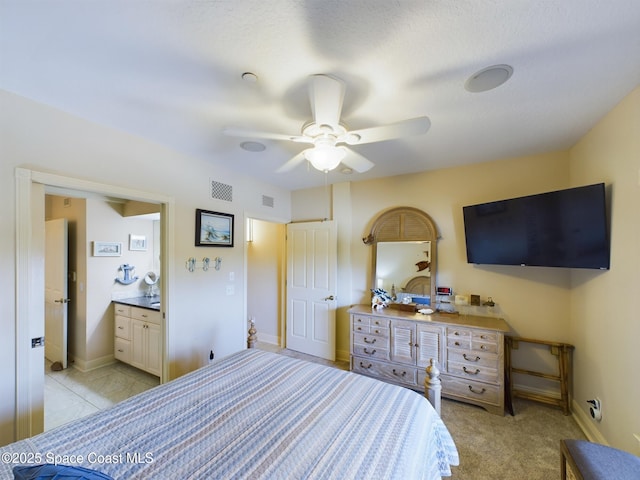 bedroom featuring ceiling fan and ensuite bathroom