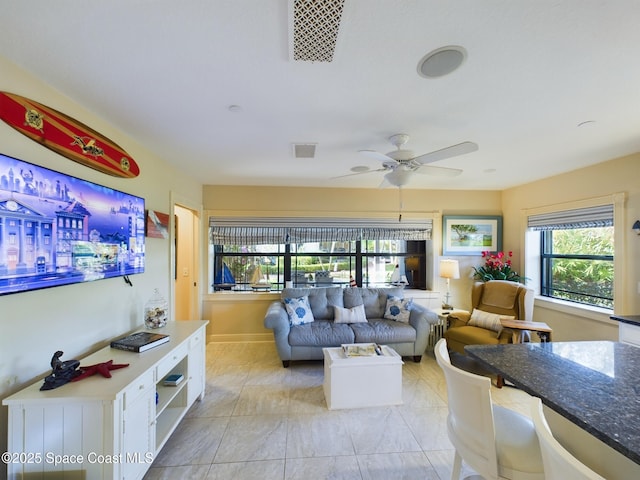 living room with a wealth of natural light and ceiling fan