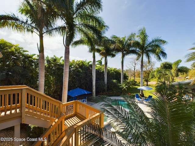 view of swimming pool featuring a deck and a patio