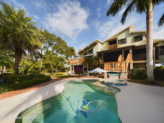 view of swimming pool featuring an in ground hot tub