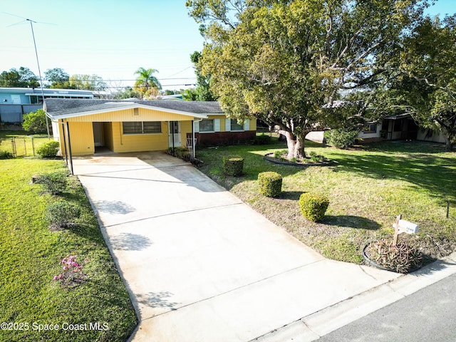 single story home featuring a front lawn and a carport