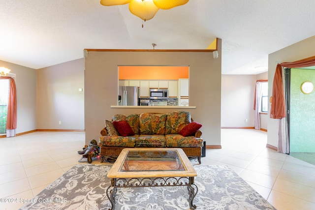 tiled living room with vaulted ceiling and ceiling fan