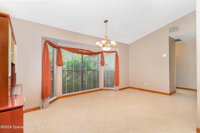 unfurnished room with light tile patterned floors, lofted ceiling, and a notable chandelier