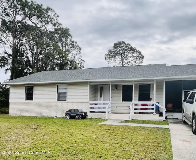 ranch-style home with covered porch and a front lawn