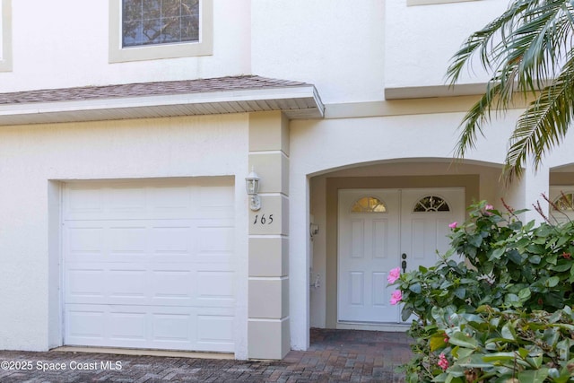 doorway to property featuring a garage