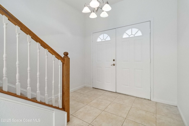 tiled entryway with an inviting chandelier