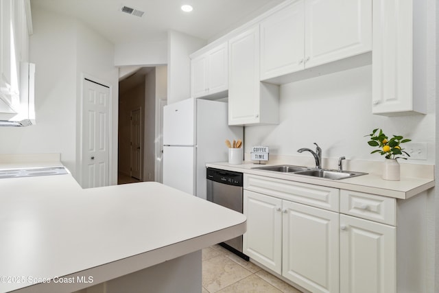 kitchen featuring white cabinets, light tile patterned floors, white refrigerator, and sink