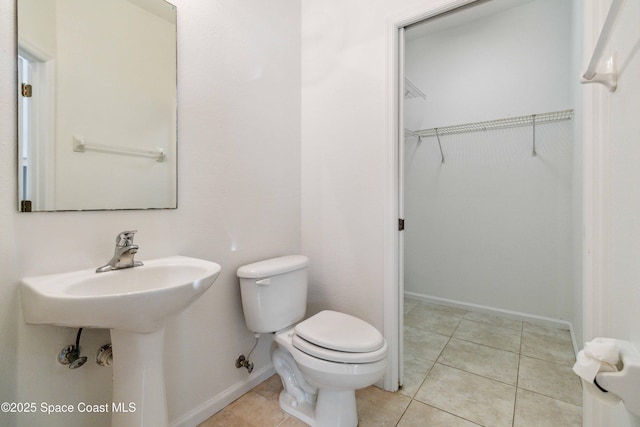 bathroom featuring tile patterned flooring and toilet