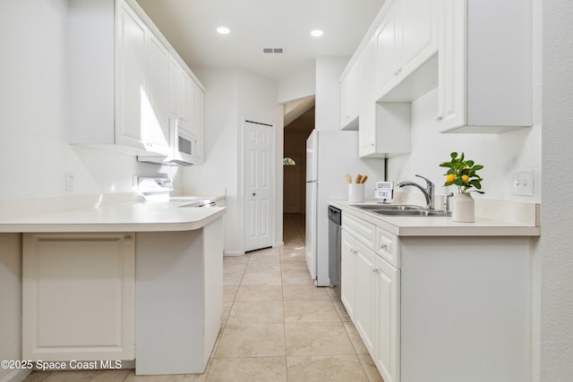 kitchen with white cabinetry, sink, light tile patterned floors, and stainless steel dishwasher